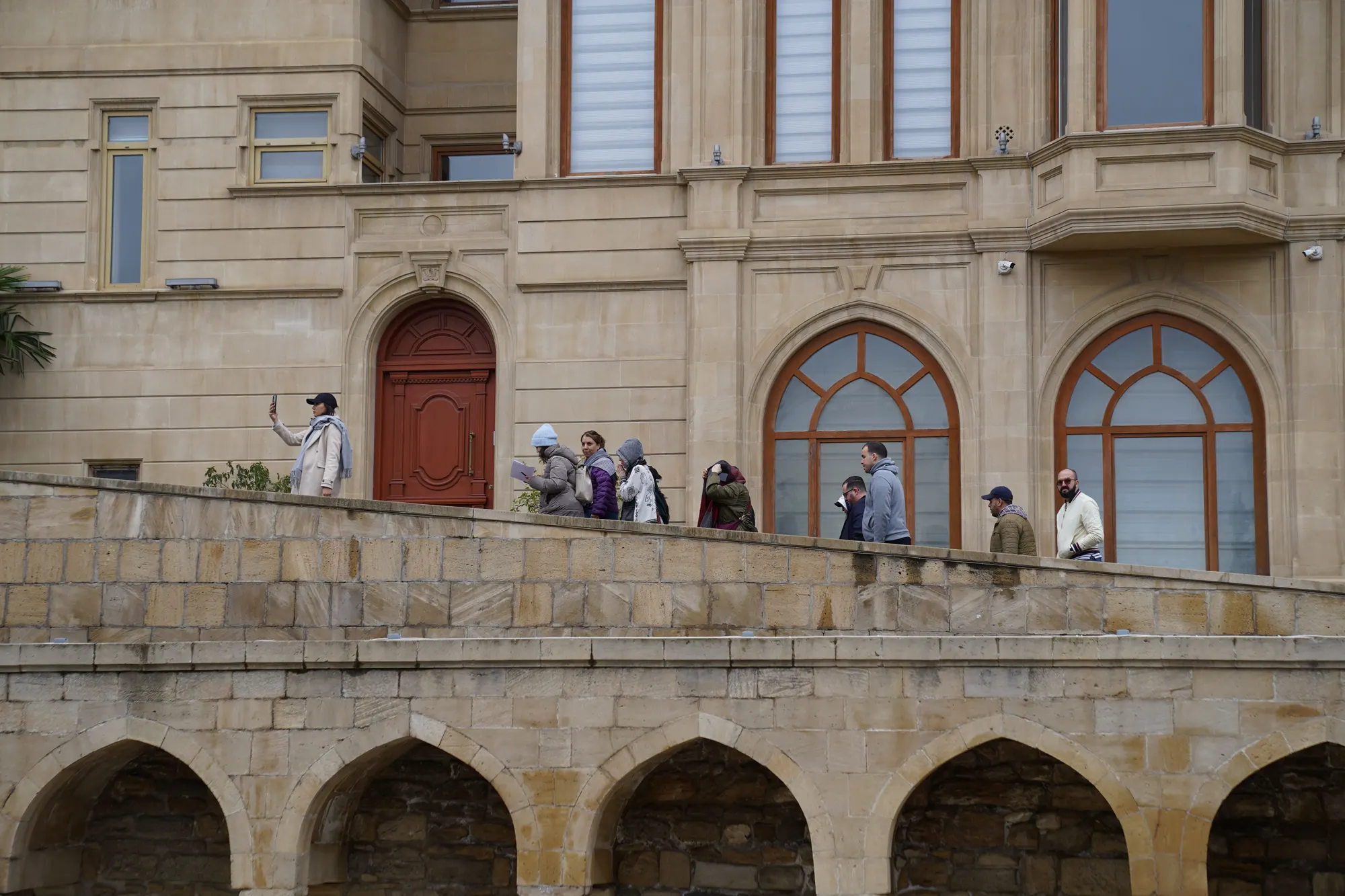 A guide leading a small group of visitors through a heritage attraction