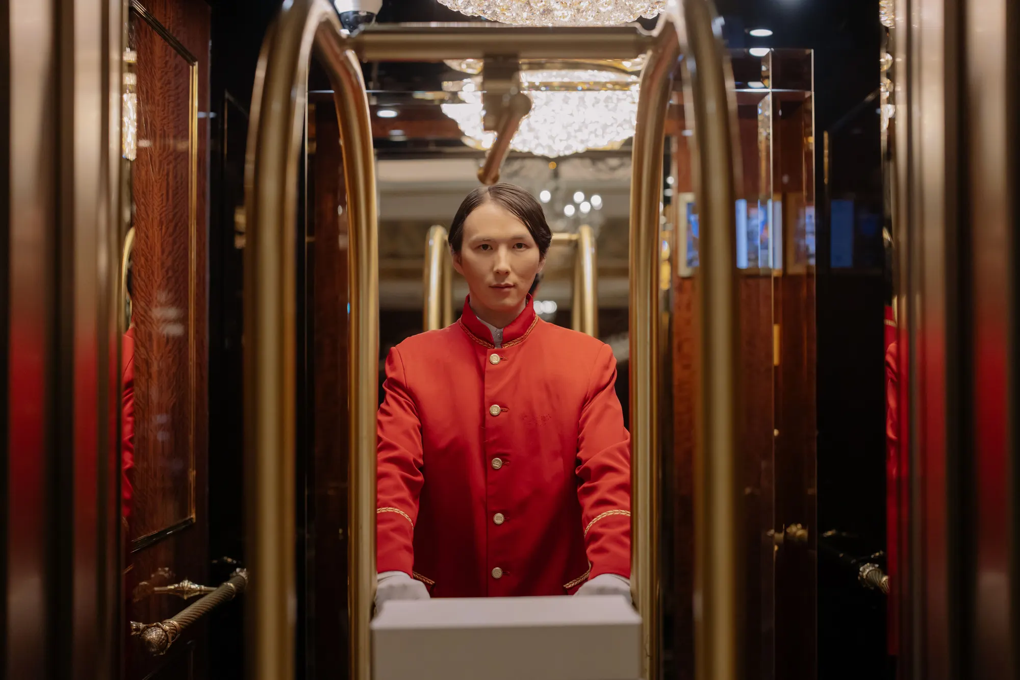 A guest arriving along a hotel corridor with luggage