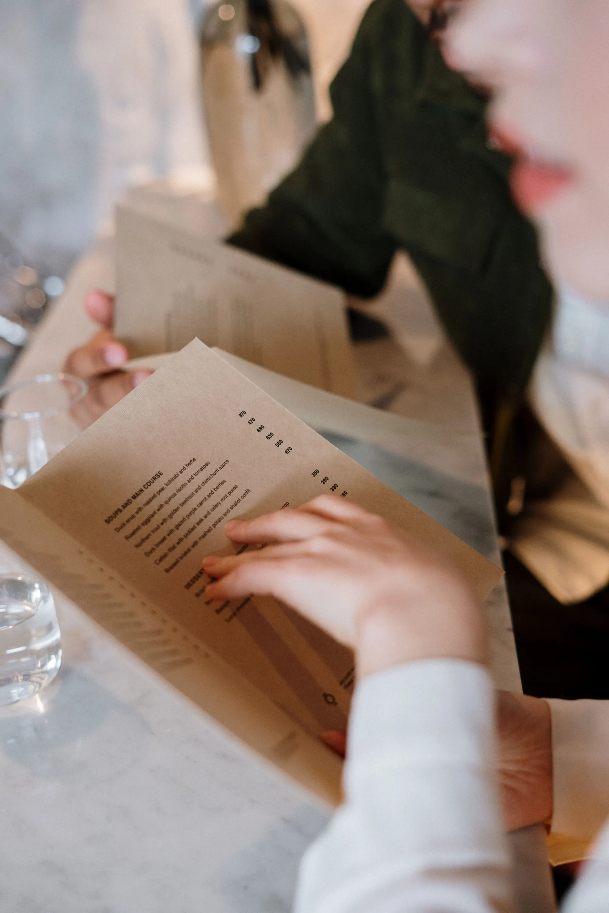 Travelers choosing where to dine from a restaurant menu