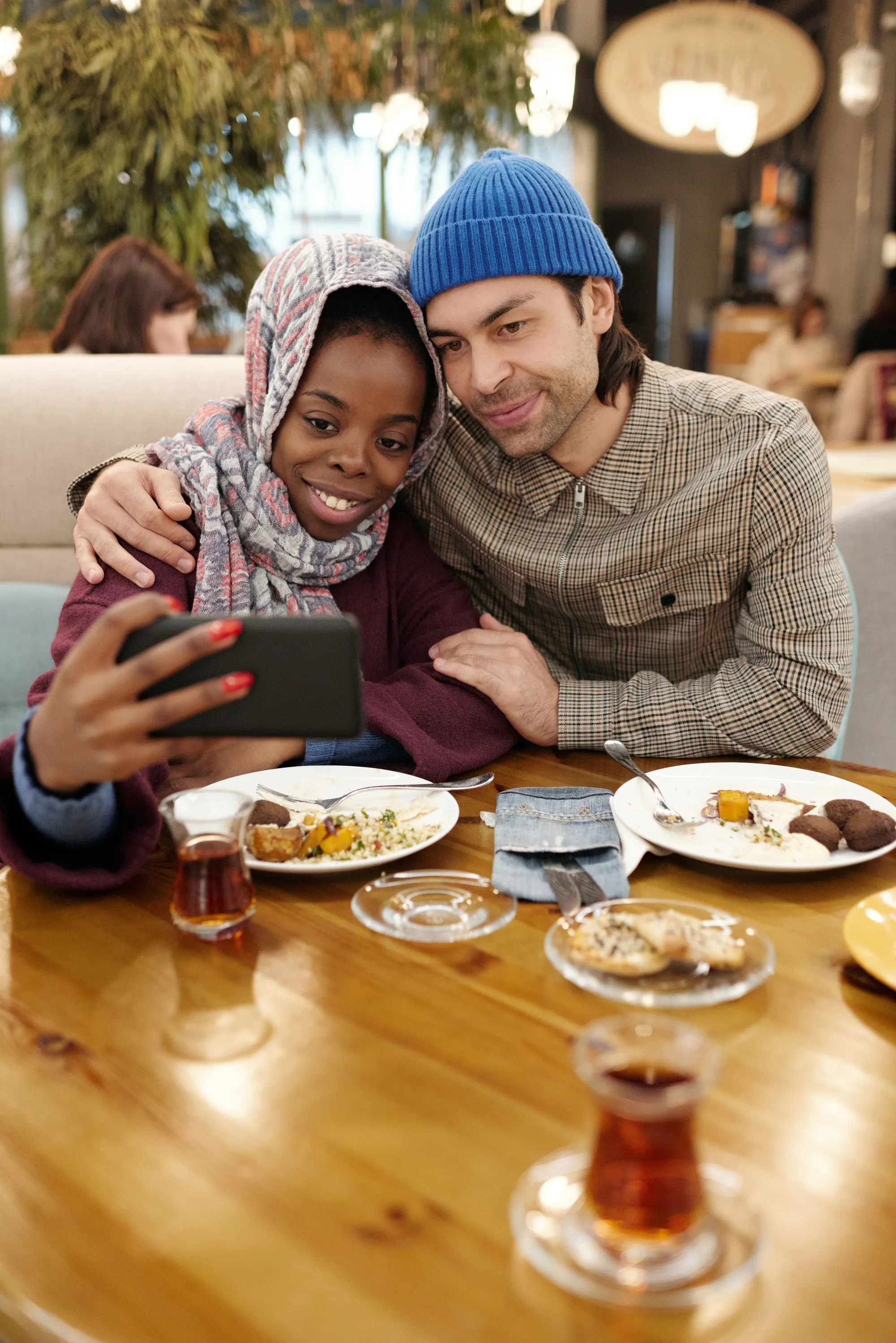 A couple sharing a favorite restaurant experience with a dinner selfie